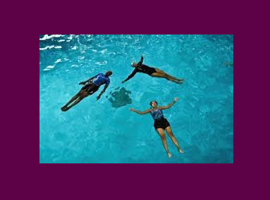Group of people floating on their back in pool